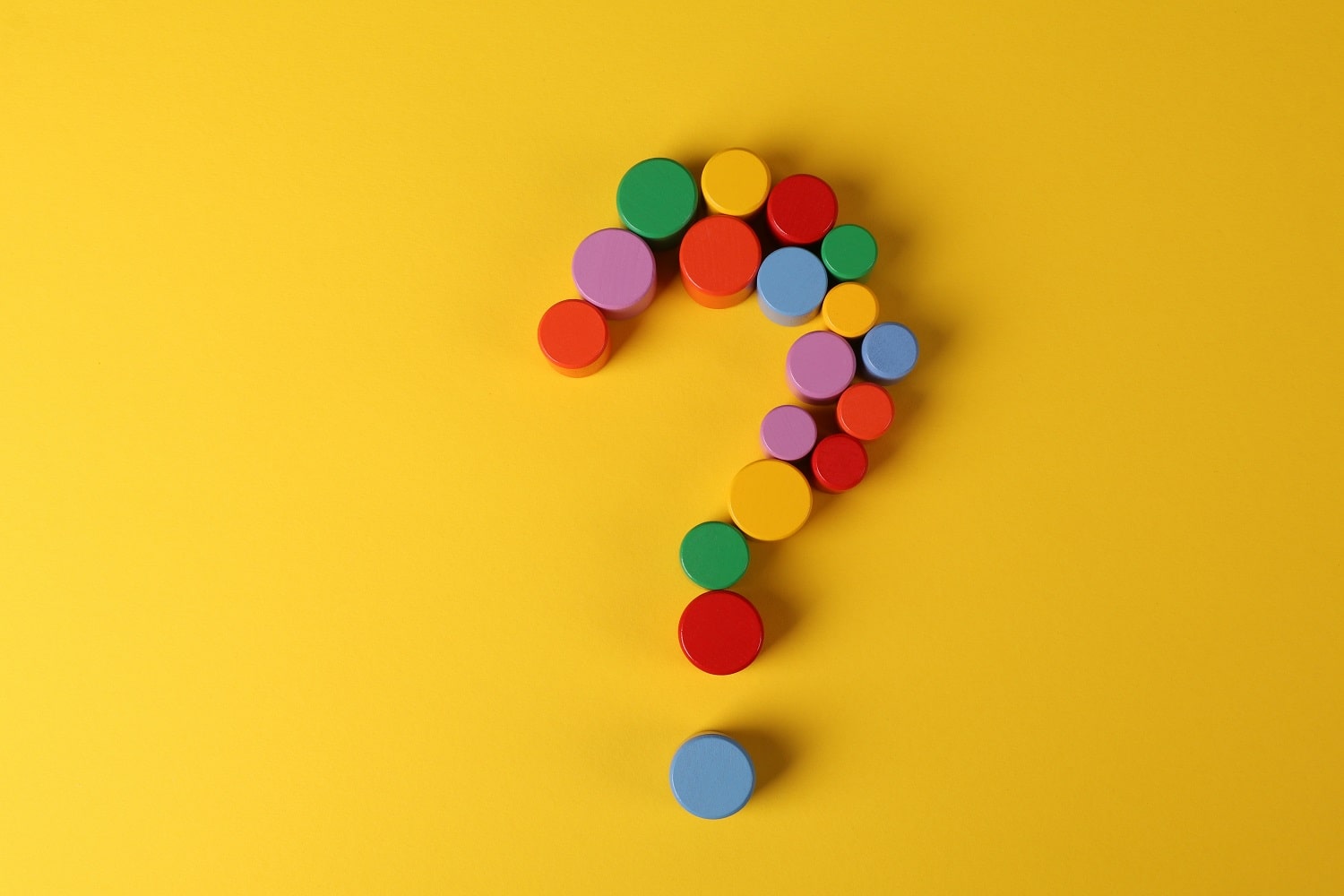 A question mark on a yellow background, representing the frequently asked questions by Amazon sellers about Amazon seller insurance.
