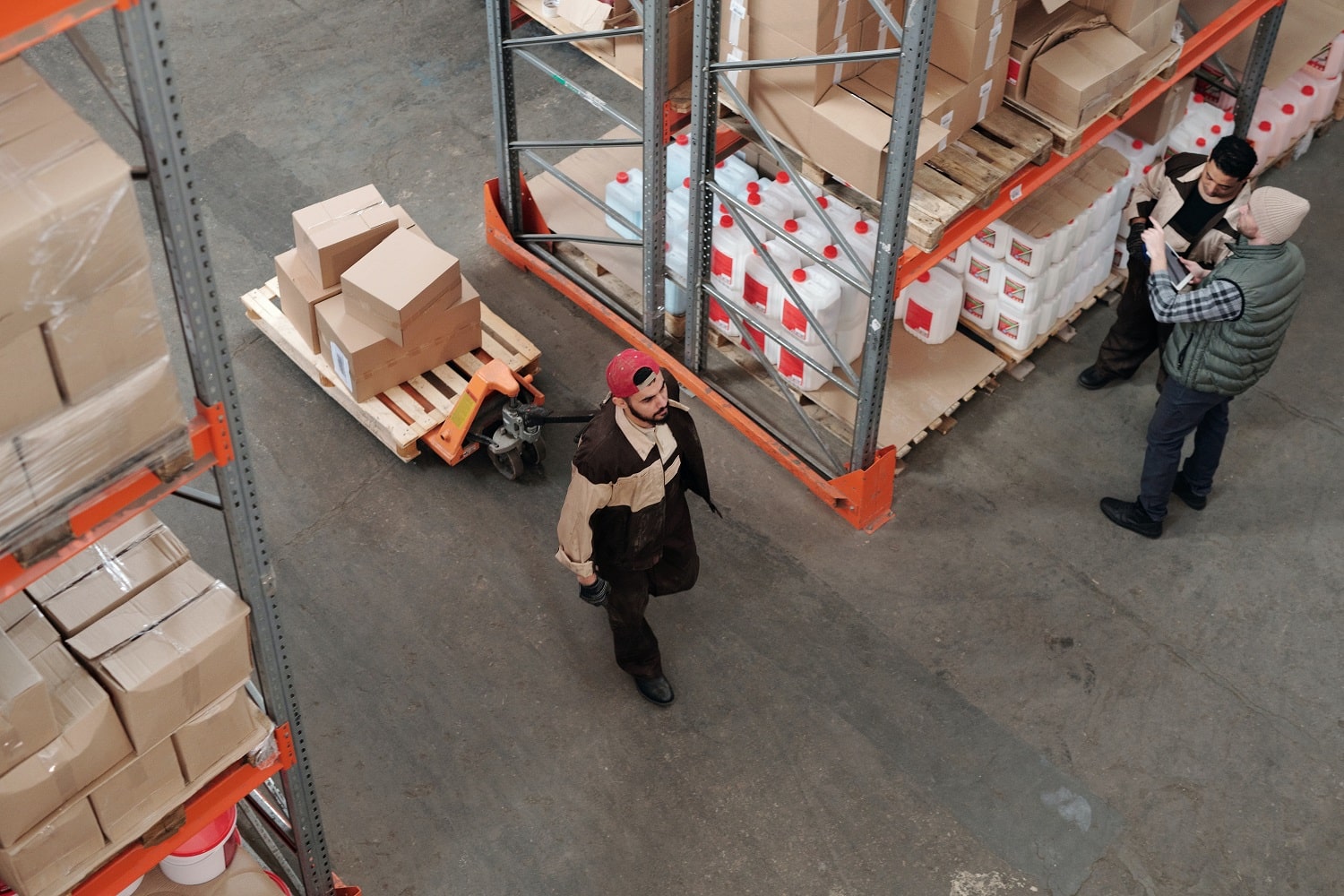 Warehouse operatives moving goods in an Amazon prep centre.