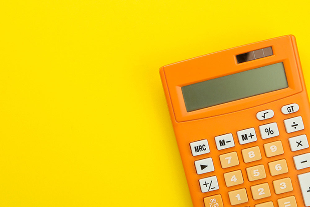A bright orange calculator sits on a yellow background, calculating your exact Amazon arbitrage return on investment.