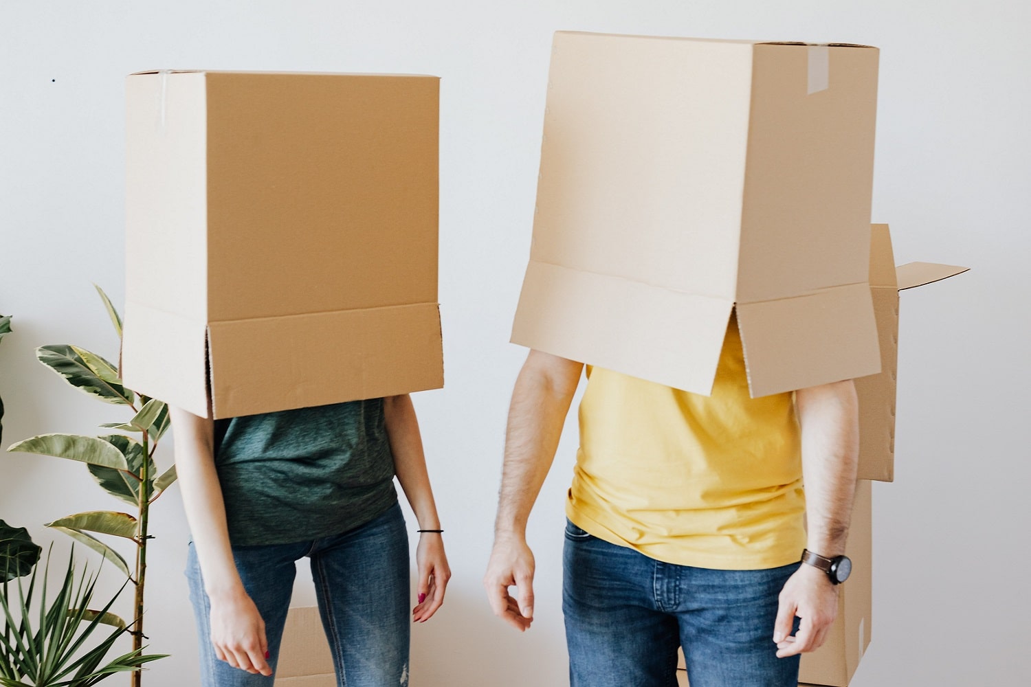 Two people with cardboard boxes on their heads, guessing Amazon shipping costs.