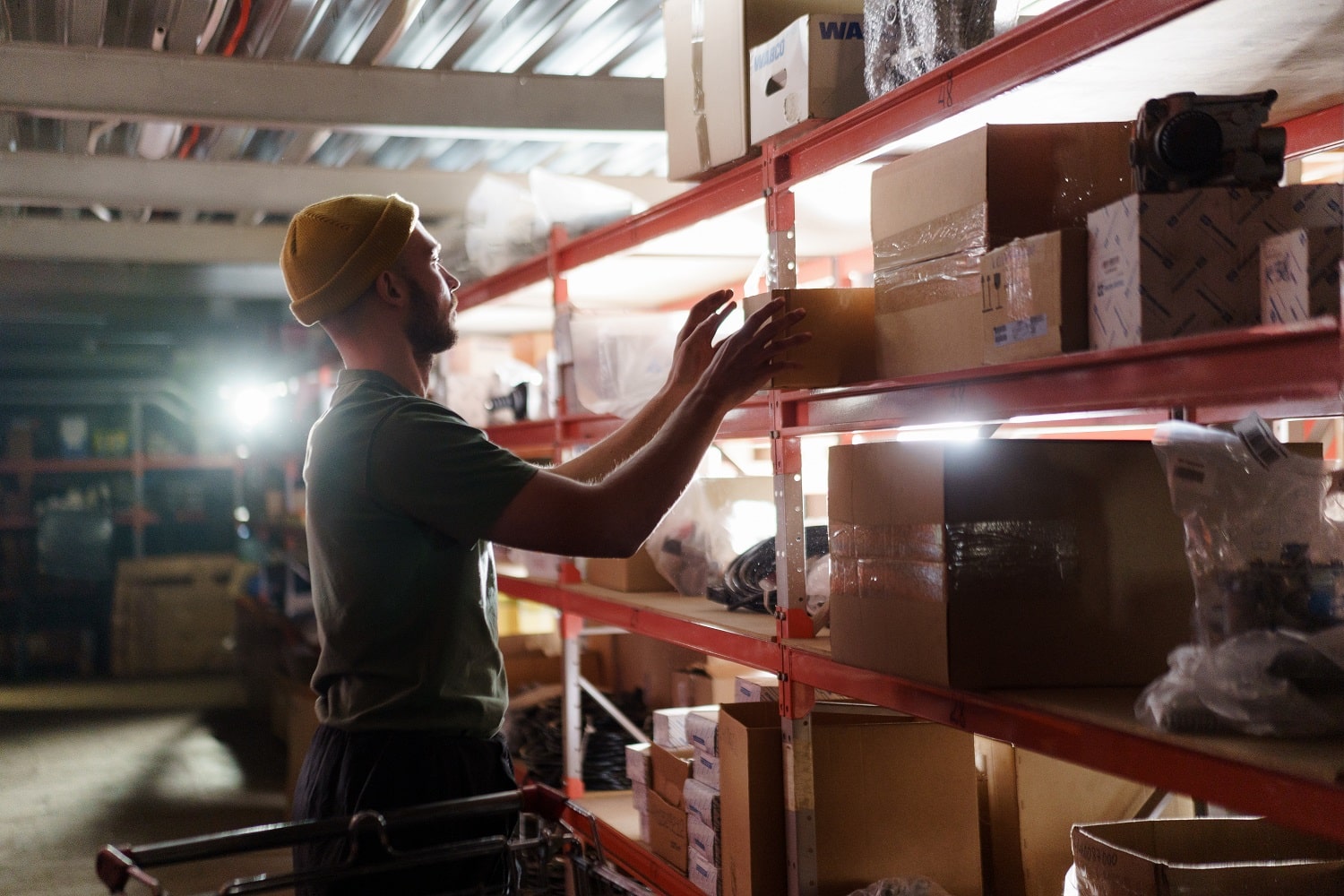 A wholesale Amazon seller searching a warehouse to find products to sell on Amazon.