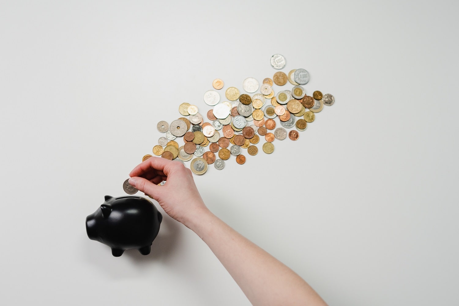 An Amazon seller using a piggy bank to manage cash flow carefully in a new Amazon business.