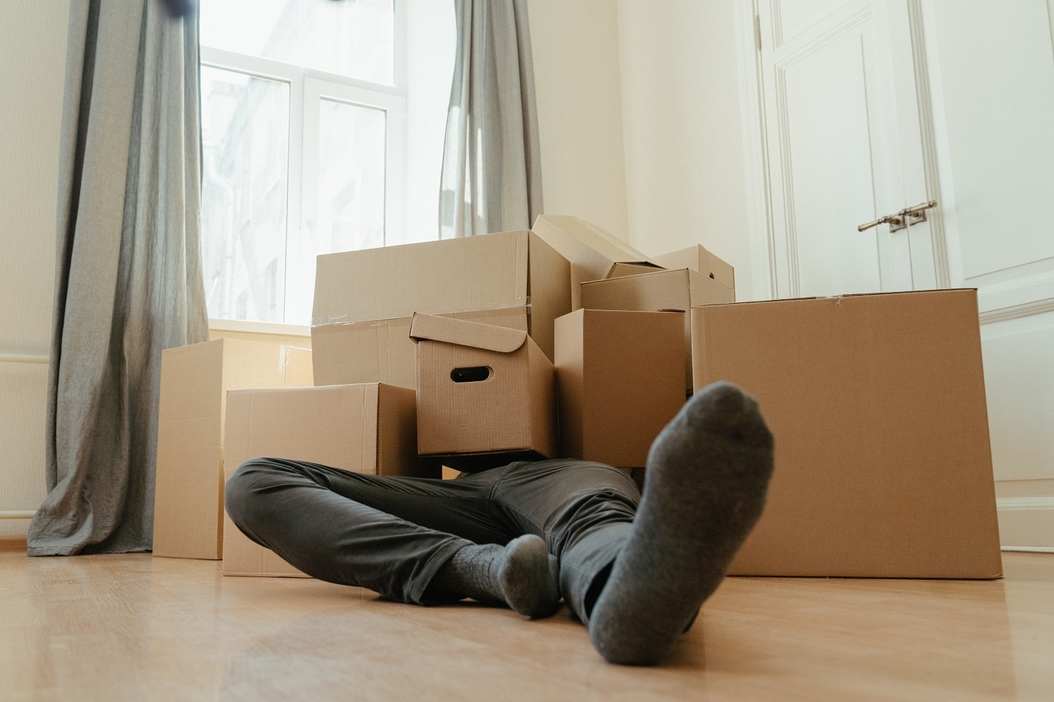 An Amazon seller covered in boxes after shipping lots of stock to Amazon from home rather than using a prep centre.